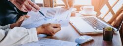 Business,Team,Analyzing,Income,Charts,And,Graphs,With,Modern,Laptop