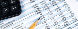 Financial income statement with calculator and pencil. Balance the investment portfolio
