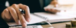 Investors,Are,Calculating,On,Calculator,Investment,Costs,And,Holding,Cash