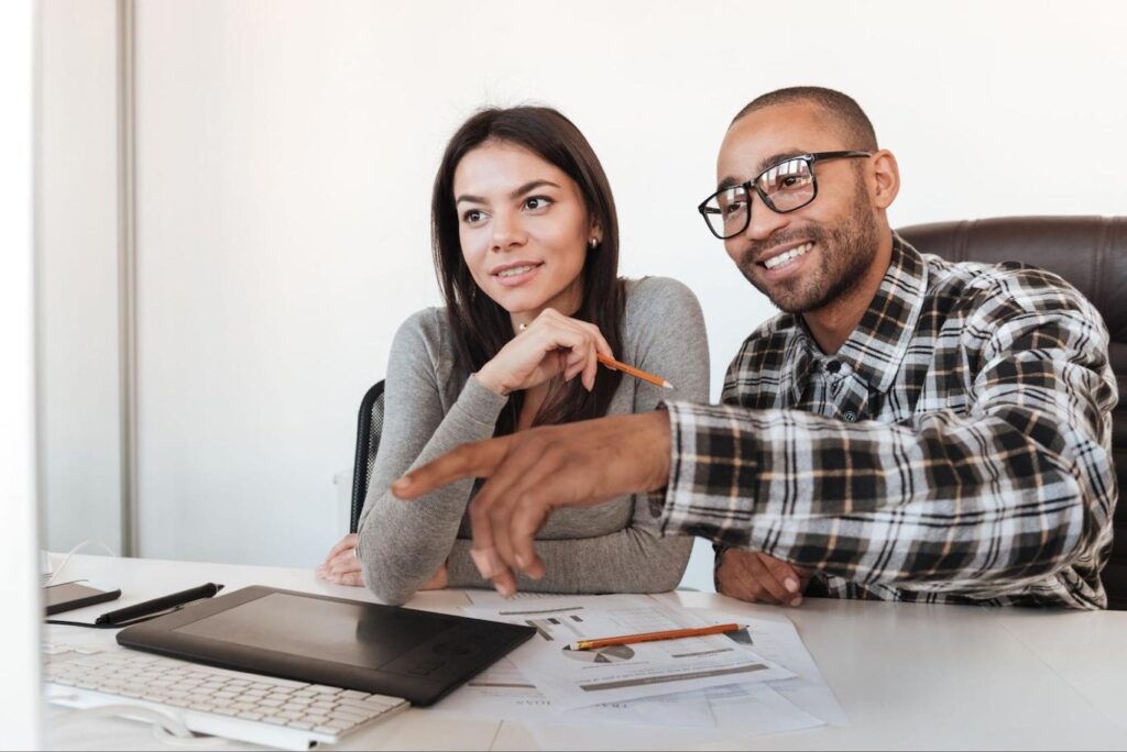 Young couple researching their mortgage options on a computer.