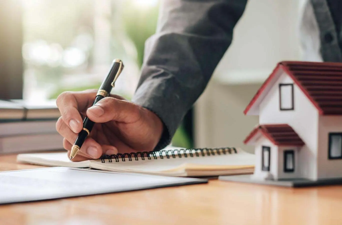 Close up of man taking notes in a mortgage lender’s office