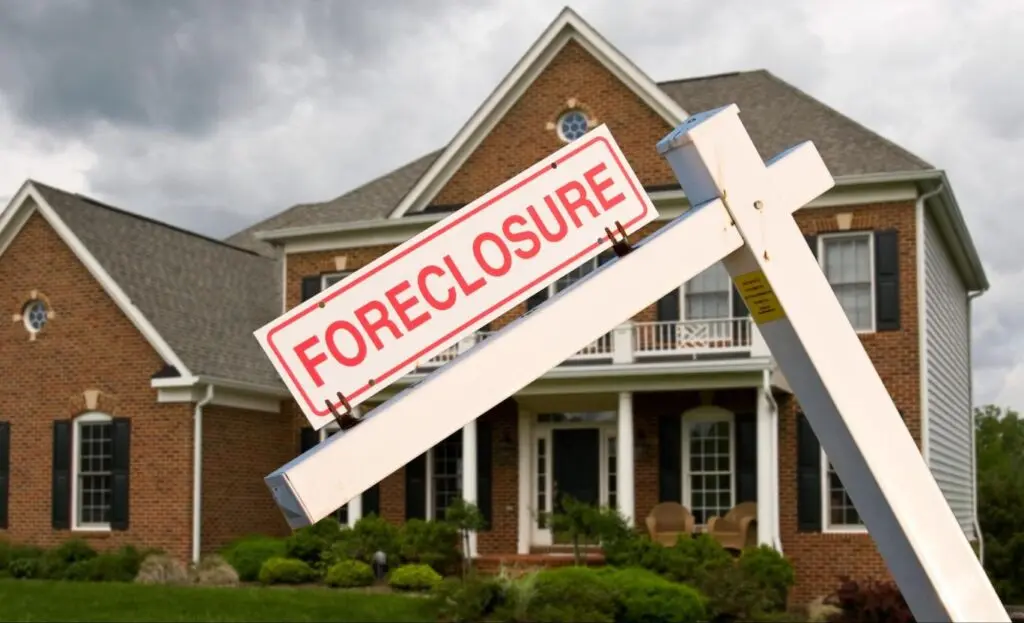 A tilted foreclosure sign placed in front of a home.