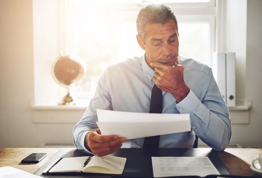 Image of a lender reviewing documents in an office.