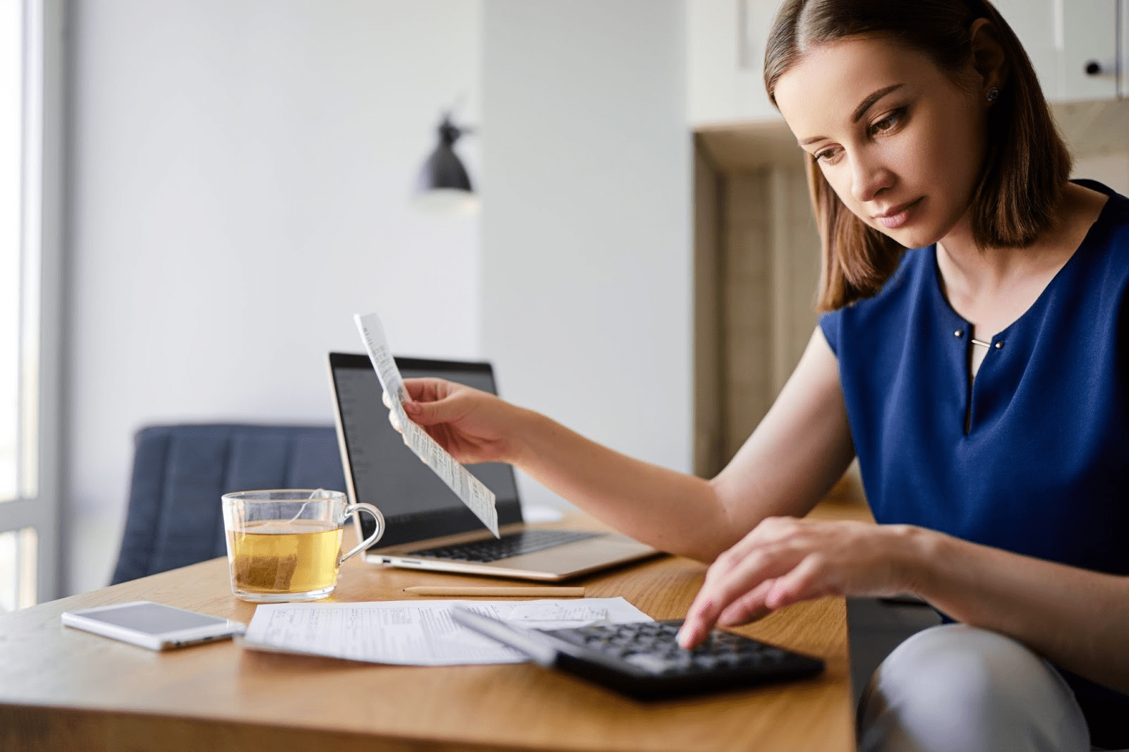 Woman reviewing bank statements for a bank statement loan 
