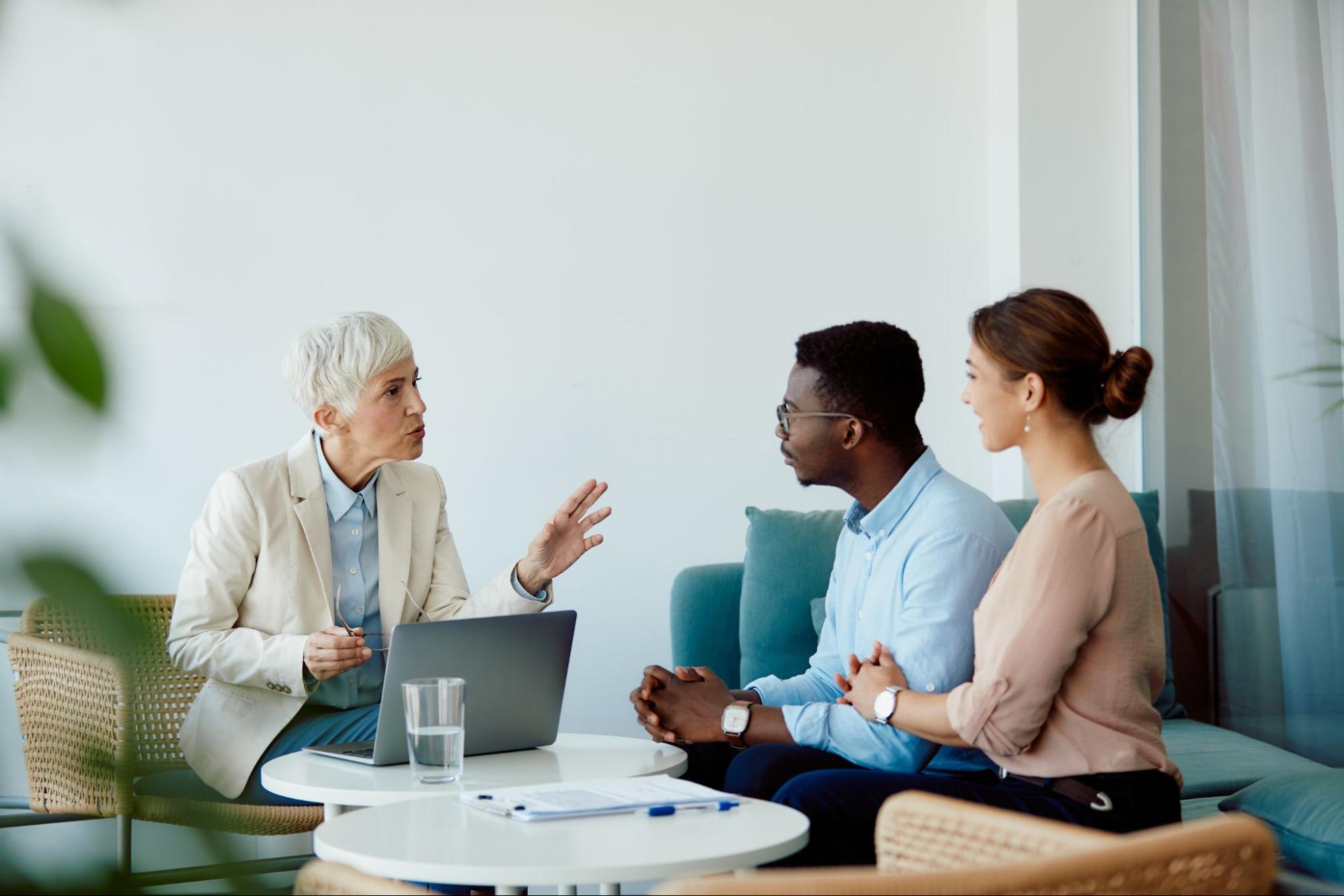 A young couple speaking with their mortgage lender.