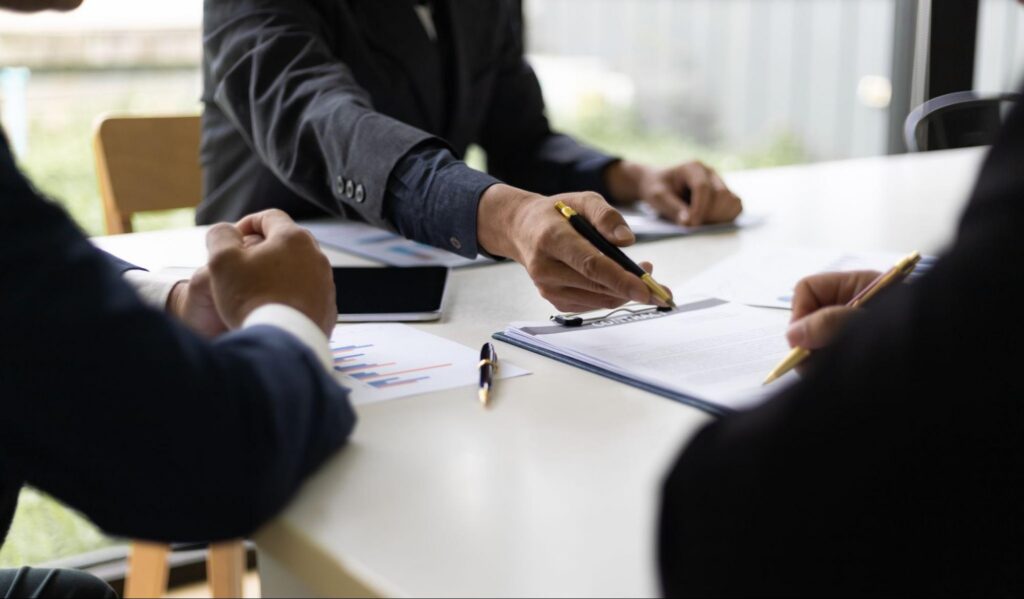 A mortgage professional reviewing financial documents with clients.