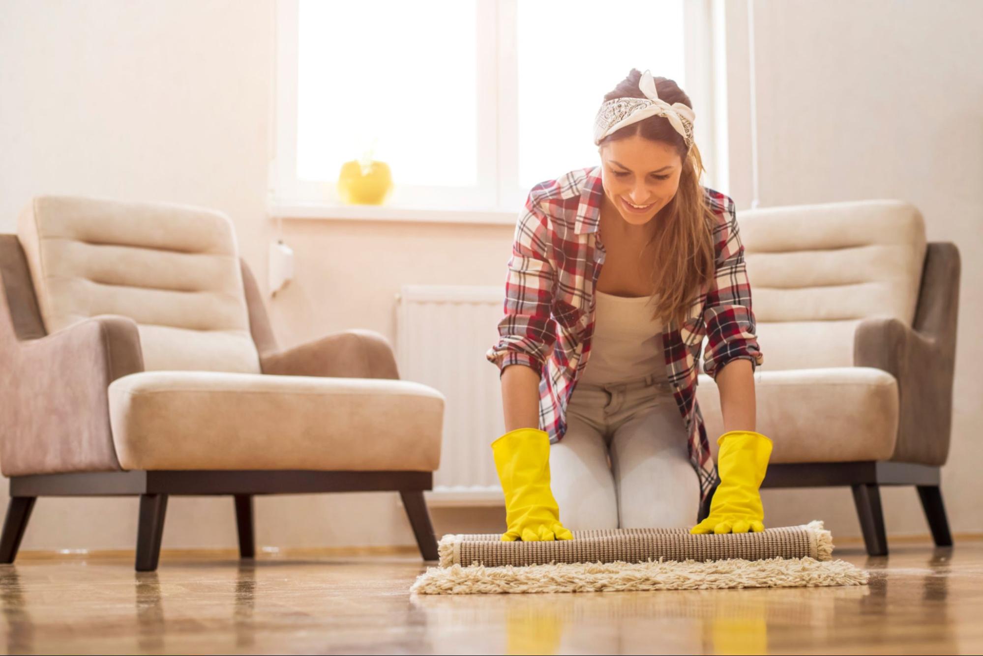 A woman cleans her floors during the spring. 