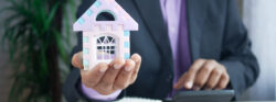 The,Concept,Of,Finance,Concept,,,Man,Holding,House,In The,Concept,Of,Finance,Concept,,,Man,Holding,House,In