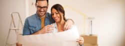 image1 Smiling couple reviewing renovation blueprint.