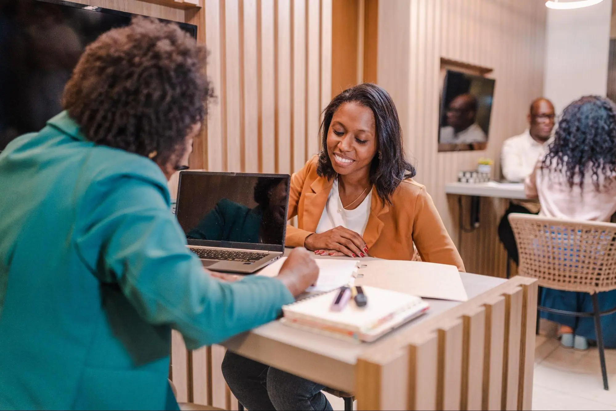 A woman at the bank speaking with her mortgage lender.