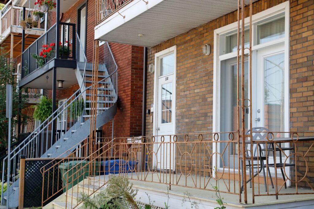 Brick multi-unit residential property with exterior staircases and balconies