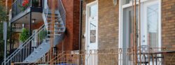 Brick multi-unit residential property with exterior staircases and balconies